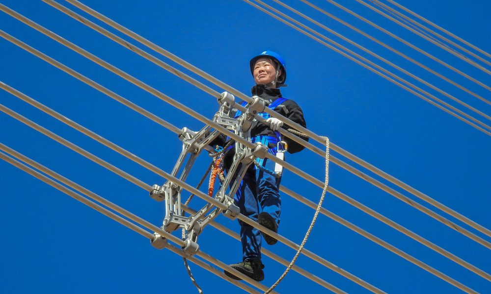 蒙東電力檢修公司錫林浩特輸電運檢分中心女子特高壓輸電班成立于2016年7月，前后招收兩批共10名女員工，她們中有一半來自其他省份，都是“90后”。兩年來，姑娘們以不甘無為、自強自立、勇于進取的精神，在人煙罕至、氣候嚴酷的茫茫荒野上挑戰(zhàn)著特高壓“禁區(qū)”。王林夢在1000千伏特高壓勝錫線線路上進行走線驗收。（作者：李廣杰）